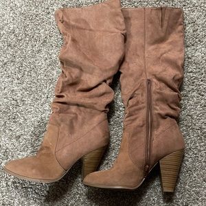 Tan knee high boots with heel.